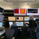Six researchers look at computer monitors in the Near Experimental Hall.